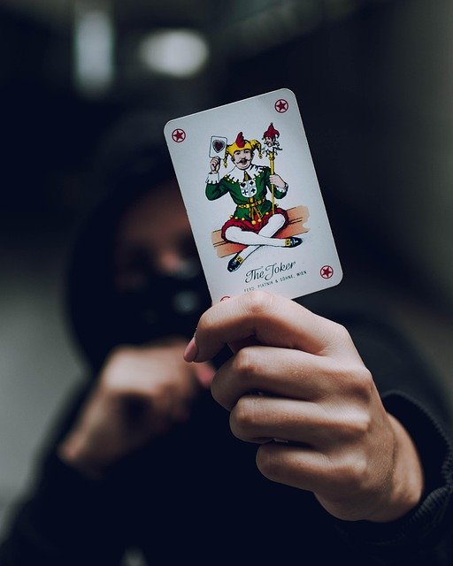 Guy in a hoodie holding a card